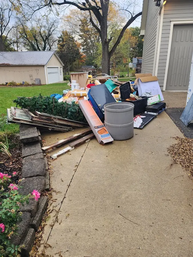 Dumpster being loaded with debris for Roofing Dumpster Rental in Rossville